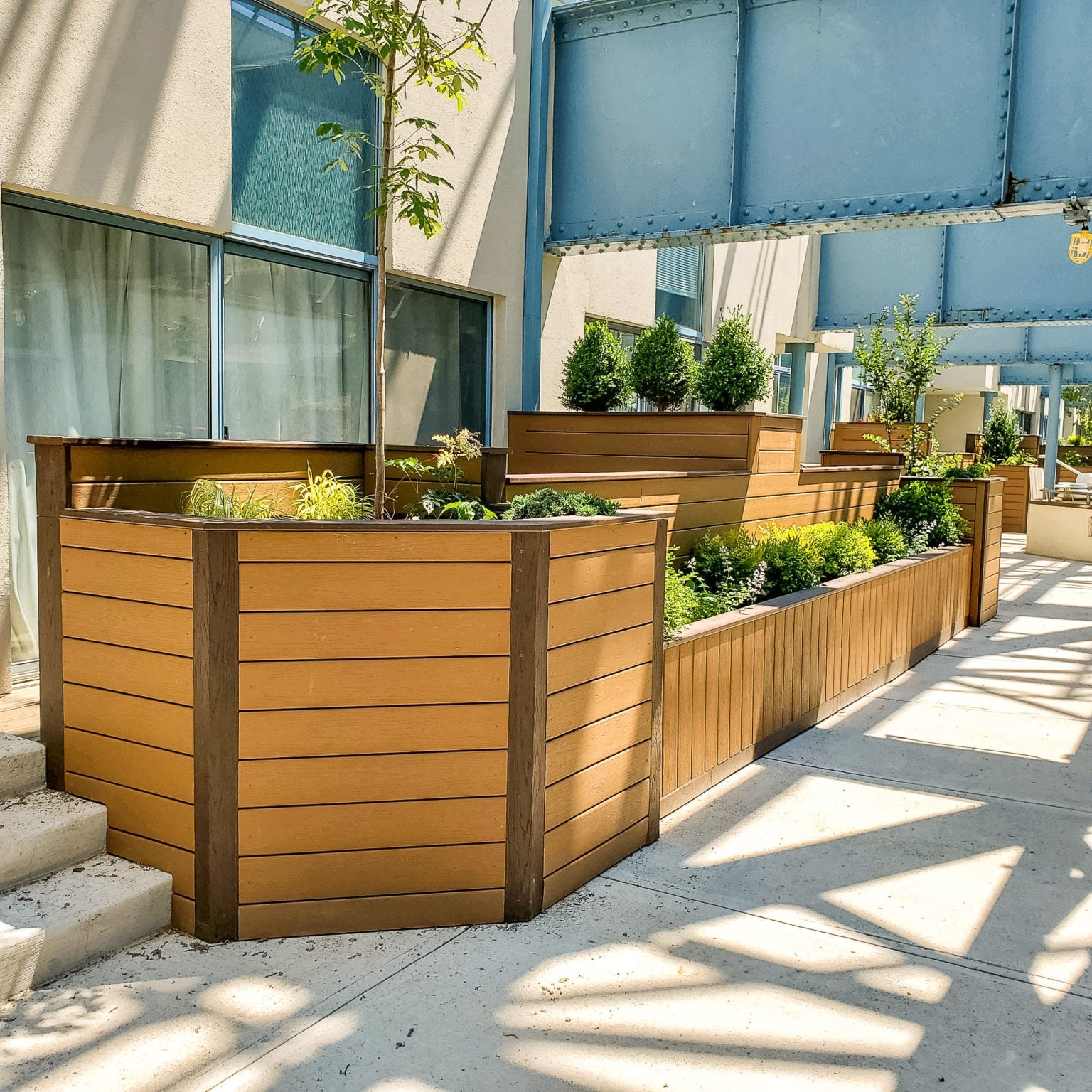 Tiered outdoor planters alongside a building, shown as an application reference